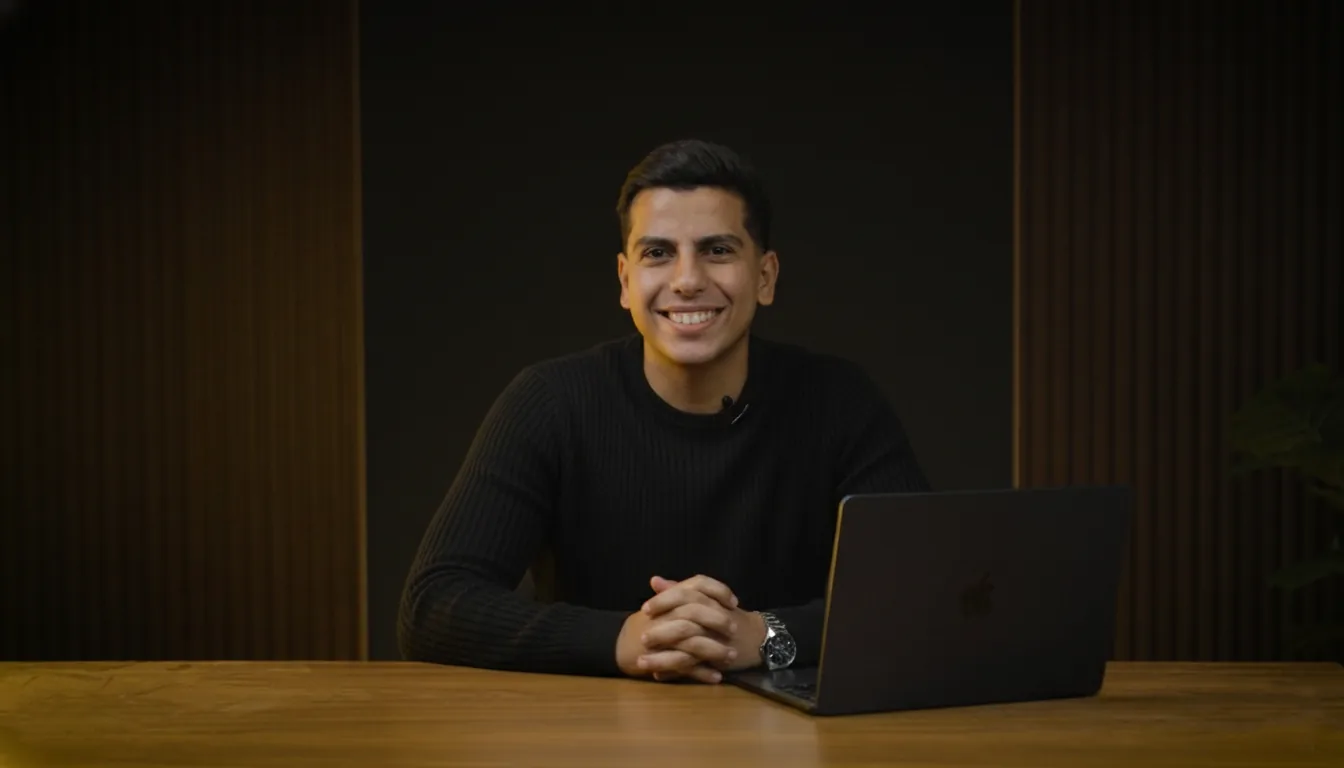 Mohamed Solyman smiling at a desk with a laptop